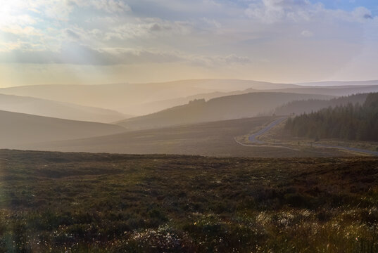 Sunset Over the Misty Countryside of Kielder Northumberland Capturing the Tranquil Landscape Under a Cloud-Filled Sky