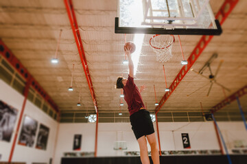 Basketball player dunking indoors photo © Rawpixel.com