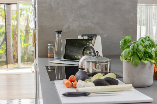 Healthy cooking and remote work in modern open kitchen