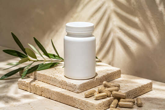 Supplement Capsule Bottle Mockup with Natural Leaves and Stone Platform