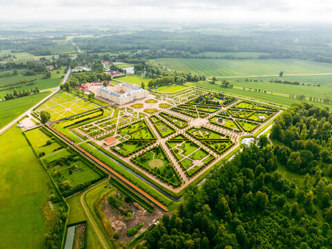 Aerial view of Rundale Palace Museum with its elaborate baroque formal gardens, geometric hedges, and surrounding green fields in Pilsrundale, Bauska Municipality, Latvia.