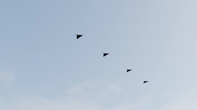 Swarm of combat drones flying overhead, view from the ground below