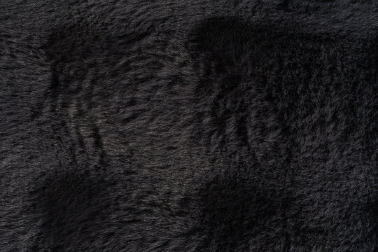 Graphite faux fur texture with rich vertical plush pattern and soft silky fibers, premium luxury background for Black Friday sale designs, fashion campaigns and upscale branding