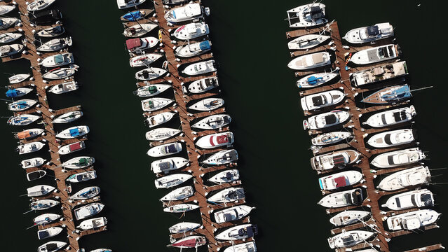 Aerial view of a marina filled with numerous yachts and sailboats docked in orderly rows in San Diego, California, United States.