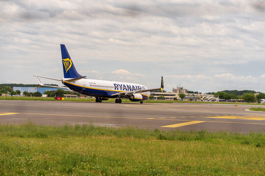Ryan Air commercial passenger airplane taxiing on the asphalt tarmac and takeoff at an airport runway in Romania