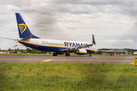 Ryan Air commercial passenger airplane taxiing on the asphalt tarmac and takeoff at an airport runway in Romania