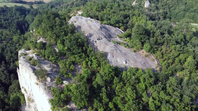 Aerial view of Sasso di Sant Andrea, a prominent sandstone geological feature surrounded by dense forest. Zocca, Modena, Emilia-Romagna, Italy