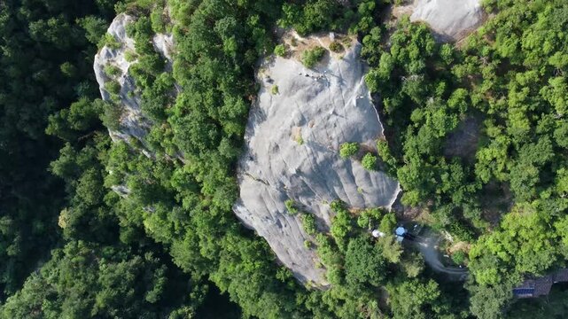 Aerial view of Sasso di Sant'Andrea, a prominent sandstone geological feature surrounded by dense forest. Zocca, Modena, Emilia-Romagna, Italy