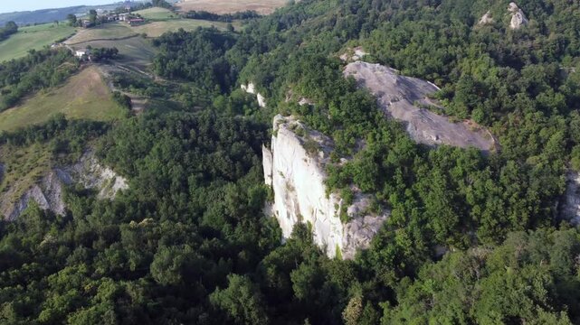Aerial view of Sasso di Sant Andrea, a prominent sandstone geological feature surrounded by dense forest. Zocca, Modena, Emilia-Romagna, Italy