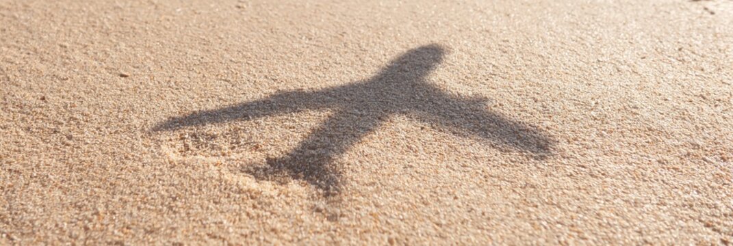 airplane shadow on sandy beach