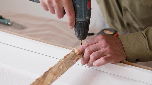 sequence shows adult hands at center right drilling and fixing rough wooden strip onto white panel on workbench, with beige clothing, tape measure, blurred tools,