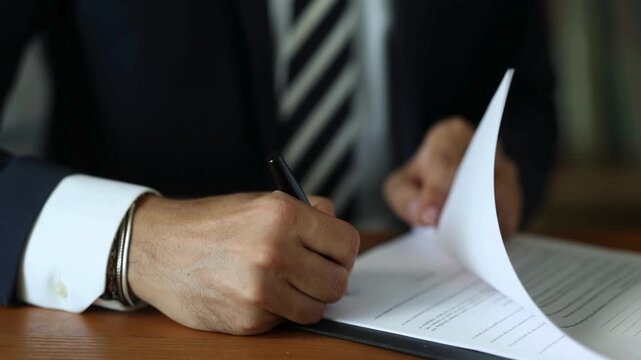 Businessman Hands Signing Official Contract Document with Pen
