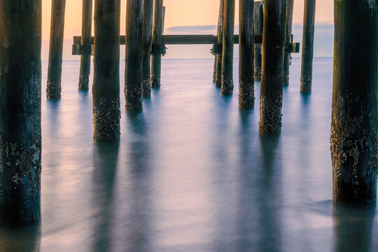 Long exposure photograph of the waterfront at Buckroe Beach in Hampton Virginia on a peaceful morning around sunrise