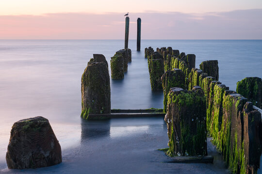 Long exposure photograph of the waterfront at Buckroe Beach in Hampton Virginia on a peaceful morning around sunrise