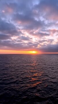 sailing at sunset on calm ocean waters with golden sky reflections and peaceful seascape views.