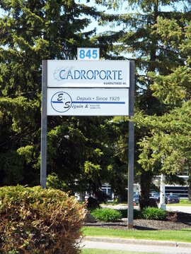 Gatineau,Quebec, Canada &ndash; May 15, 2026: An outdoor standing sign for "Cadroporte Manufacturier Inc. and E. S&eacute;guin & Fils Lt&eacute;e", located at 825 Bd de la Carri&egrave;re.