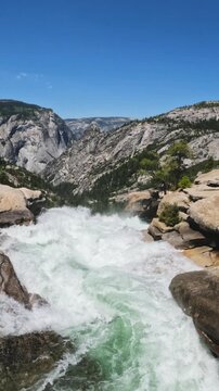 top of Nevada Fall featuring the Merced River, granite rock formations, mountain scenery, and wilderness landscapes in Yosemite National Park, California.