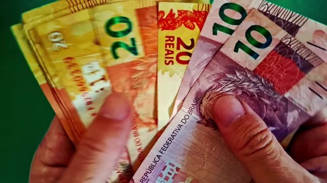 Brazilian real banknotes held in hand for financial motion clip