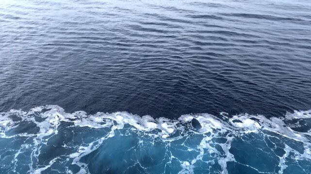 Cruise ship sailing through the open ocean with calm blue waters, horizon views, and peaceful maritime travel scenery.