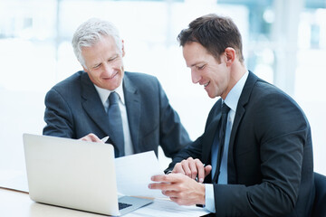 Corporate, people and paperwork at law firm with laptop, manager advice and legal aid for court case. Attorney, men and conversation in office with computer, documents and collaboration for lawsuit.