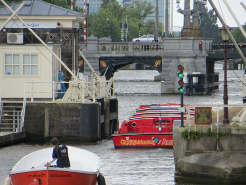 Amsterdam / Netherlands - June 2016: View of the Amstel River, Amstelsluizen and boats, Amsterdam.