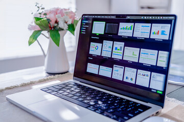 Fototapeta premium Laptop with business analytics dashboard in home office