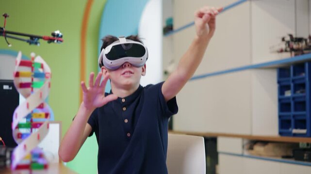 Tracking shot of boy wearing vr headset reaching and manipulating virtual objects in colorful stem classroom lab with handheld smooth movement.