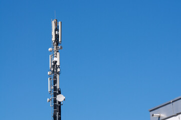 Obraz premium Cell tower telecom mast with 5G antennas against blue sky in Mendrisio, Switzerland
