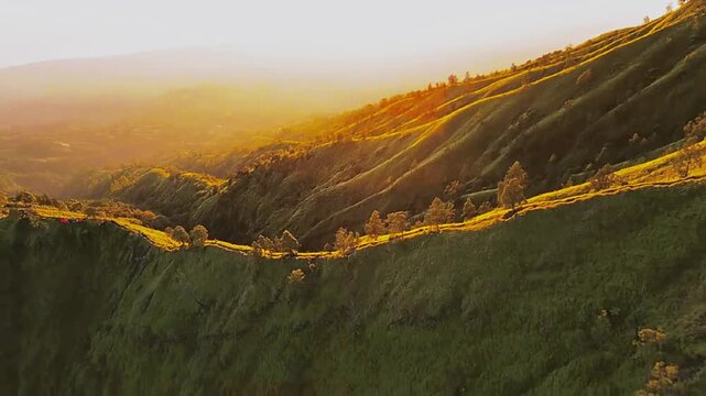 Golden Sunrise Over Rolling Mountain Hills and Valley Landscape