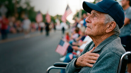 Elderly man in wheelchair with hand on heart watching Independence Day parade. Emotional veteran patriot celebrating Fourth of July with American flag. National holiday pride and respect.