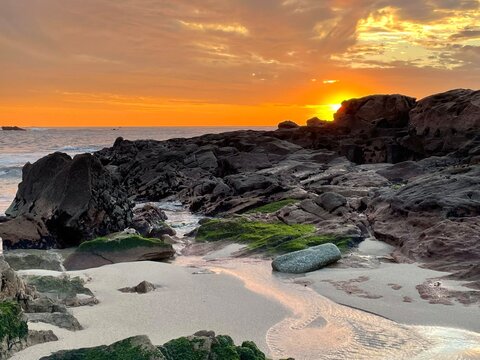 Golden sunset over the rocky beach of Caxinas in Vila do Conde, Portugal