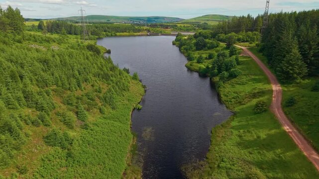 High angle perspective of a reservoir in Wales with a dirt track running alongside
