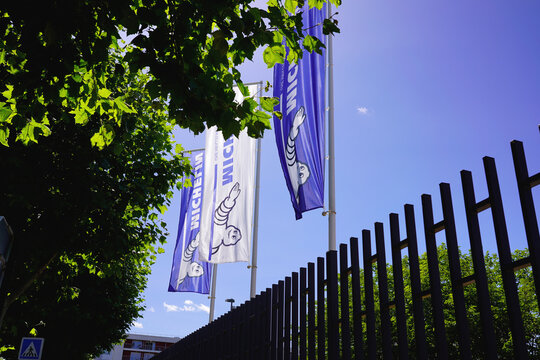 CLERMONT-FERRAND, FRANCE - JUNE 12, 2026: Michelin corporate flags waving in the wind