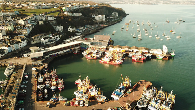 Aerial view of fishing boats docked at the harbor in Brixham, England, United Kingdom.