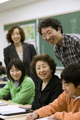 Fototapeta premium Teacher Explaining Lesson to Japanese Students