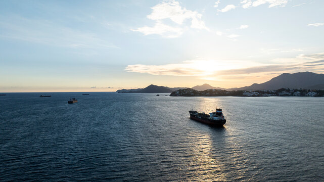 Cargo Ship Sailing Through Manzanillo Bay at Sunset