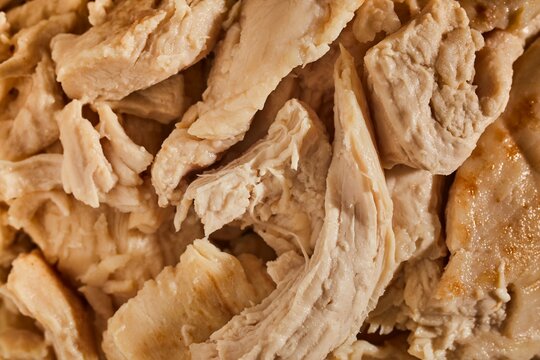 A bowl of cooked chicken pieces.