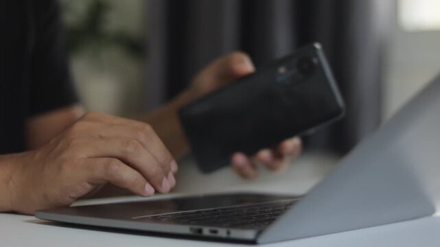 Cybersecurity, Cyber security 2FA login concept. Man hand using two step authentication and verification online account login with laptop, smartphone. Remote work, freelancing, banking and shopping.