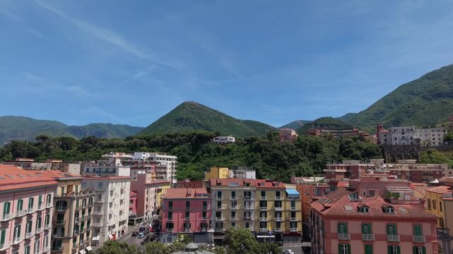Aerial drone view of Castellammare di Stabia Villa Comunale with Cassa Armonica gazebo, colorful buildings and Monte Faito mountains, Naples, Italy
