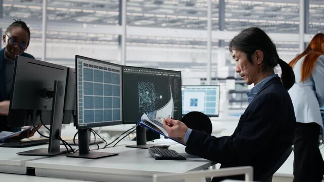 Analyzing chip architecture, AI model and senior manager in microchip factory laboratory, manufacturing concept, programming PCB layout on PC, AI and Asian man in office for semiconductor research.