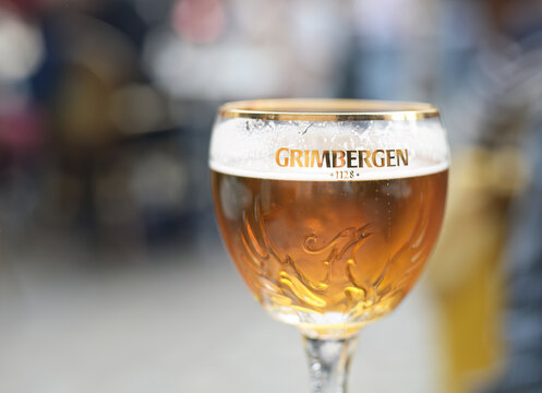 DIJON, FRANCE &ndash; APRIL 29, 2026:  Glass of Grimbergen blond, a Belgian abbey beer brand brewed in the Alken-Maes brewery in Alken, originated in 1128, selective focus