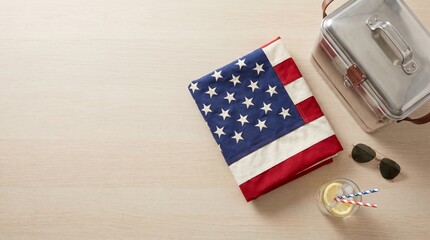 Obraz premium Folded american flag resting on a wooden table with a metal lunchbox and cold drink