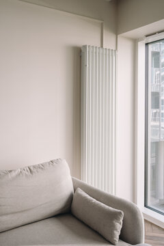 Modern apartment room with home heating radiator by window