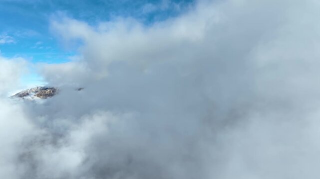 Aerial shot of the clouds and the rugged terrain of the Wasatch Mountains near Salt Lake City, Utah.
