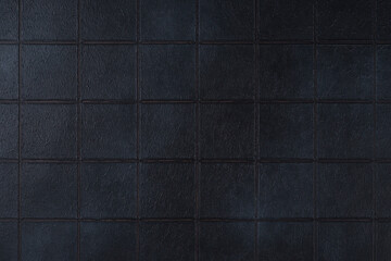 Fototapeta premium Dark black ceramic tile texture background with square pattern and subtle grunge surface. Abstract geometric wall backdrop with textured tiles and copy space. Interior element, vintage design