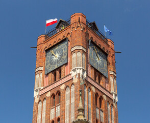 Obraz premium Close view of the Gothic clock tower of the historic Town Hall in Torun, Poland.