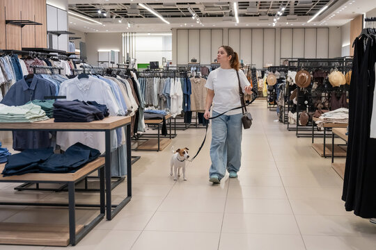 Caucasian woman in a shopping mall with a Jack Russell Terrier dog. 