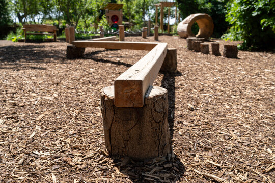 Close-up of Wooden Balance Beam on Mulch Ground in Outdoor Children's Playground