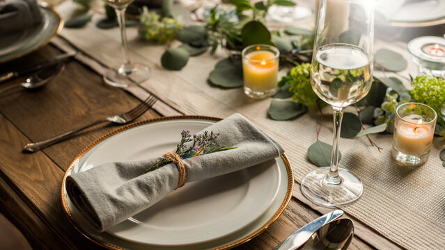 Elegant table setting with candles and greenery
