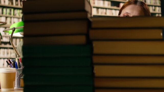 Young woman tired of reading books from tall stack at quiet library table, showing study fatigue and academic pressure during exam preparation, Finals overload.
